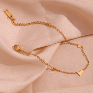18K gold plated heart pendant chain bracelet for women on elegant pink silk background
