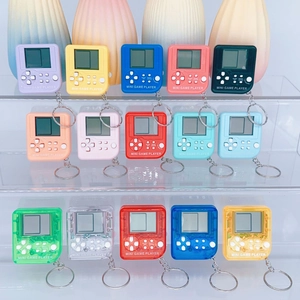 Set of 15 colorful mini tetris game console keychains on a display stand in bright colors