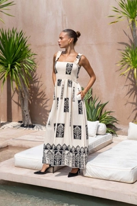 Detail of floral print off-shoulder maxi dress with vintage patterns and cotton linen texture