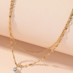 Double layered gold titanium necklace with sparkling zircon pendant and herringbone chain