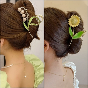 Elegant tulip and lily of the valley metal hair claw clips worn by a female model