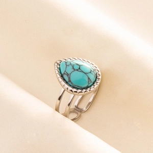 Detail of silver 304 stainless steel ring with teardrop turquoise stone and hollow band