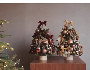 Detailed view of mini DIY Christmas tree with velvet bows and warm LED lights