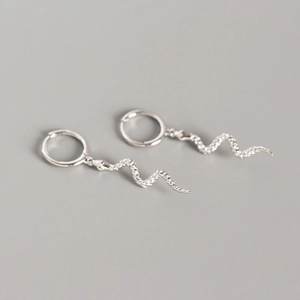 Silver snake drop earrings with minimalist geometric hoops for a luxury jewelry look