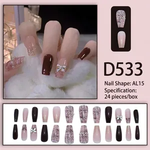 Press-on nail set with coffee and pink gradient, grid patterns, and pearl bow accents