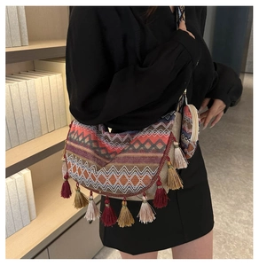 Close-up of bohemian woven crossbody bag with colorful tassels and a round coin purse pouch