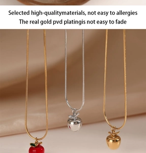 Three variants of apple pendant necklaces including gold, silver, and red enamel finishes