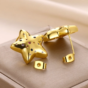 Golden star stud earrings with colorful zircon stones on champagne jewelry box