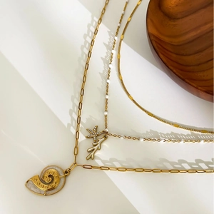 Gold titanium starfish and conch layered necklace with rhinestones on white background