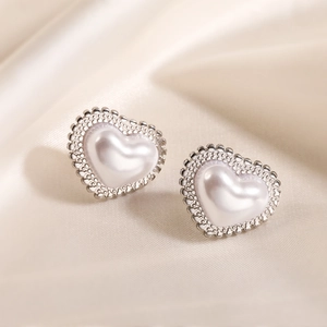 Minimalist 18K gold plated heart stud earrings with pearl white inlay on satin cloth