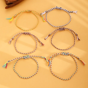Close-up of 6 colorful woven bohemian bracelets with adjustable knots and beads
