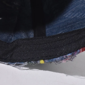 Detail of baseball cap interior showing sweatband and distress stitching on brim