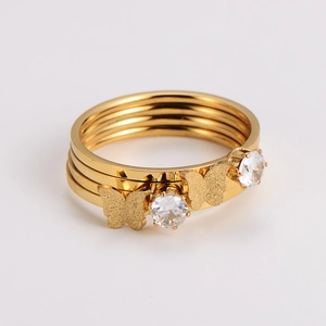 Detailed view of gold butterfly ring with triple layers and zircon stone settings