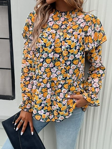 Detailed view of dark blue floral chiffon blouse with tiered hem and ruffle cuffs