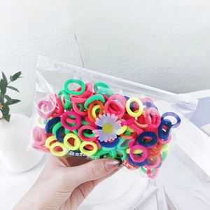 Close-up of colorful mini high-elastic hair ties for babies in daisy branded packaging