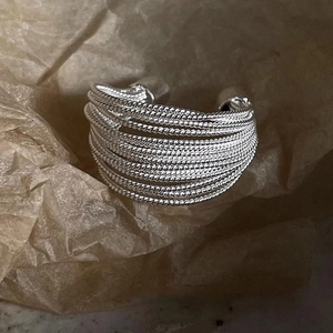 Macro shot of silver layered twisted rope ring with vintage textured metallic finish