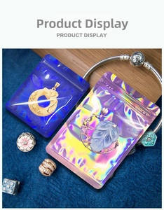 Detail of holographic jewelry resealable bags showing blue finish and charms