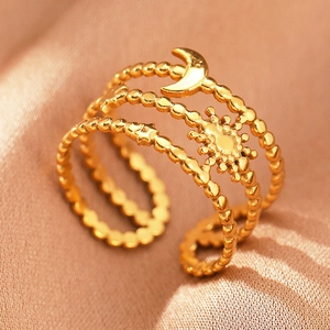Detailed view of bohemian gold stainless steel ring with sun, moon, and star charms