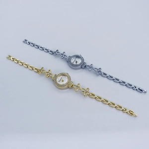 Detailed view of luxury gold and silver ladies watches with butterfly crystal link bracelets