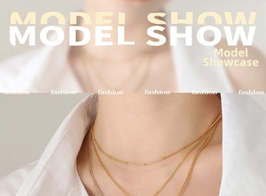 Close-up of golden multi-layer necklace set with star and moon charms on model