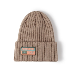 Brown knit beanie with a vintage authentic label and thick ribbed texture for winter warmth