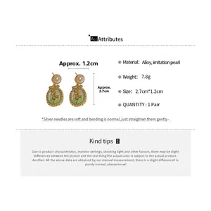 Detail of vintage oval earring with green tulip floral design and pearl stud accent