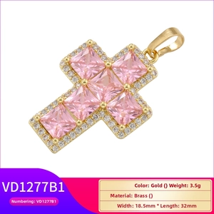 Detailed view of gold plated brass cross pendant with square pink zircon inlays