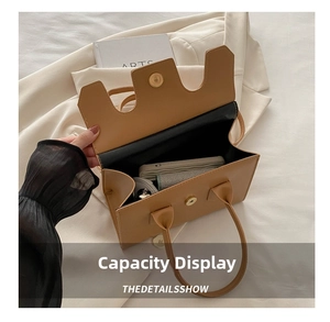 Detail showing the large interior capacity of this brown leather underarm bag