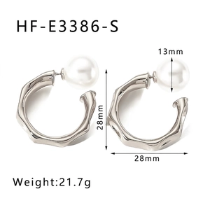 Detail view of 28mm textured silver hoop earrings with 13mm large white pearls