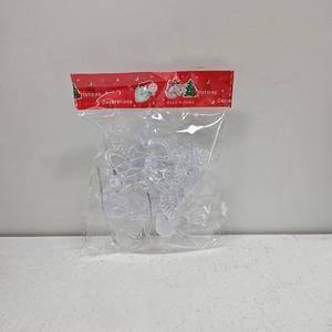 Close-up of clear acrylic angel Christmas tree ornaments in festive retail packaging