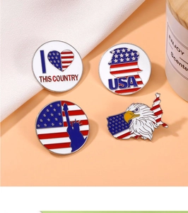 Macro detail of four patriotic US flag enamel pins with Statue of Liberty and eagle motifs