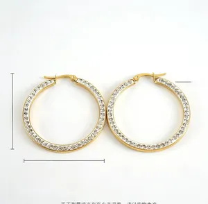 Detail of 18k gold plated stainless steel hoop earrings with sparkling zircon inlay