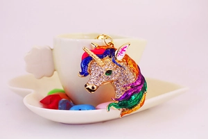 Macro detail of a colorful unicorn keychain with crystal rhinestones on a pink background