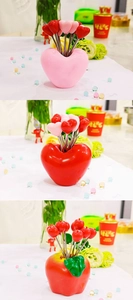 Three-frame close-up of heart and apple shaped stainless steel fruit fork sets with bases