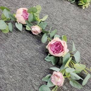 Detail of pink peony and rose garland with eucalyptus leaves for wedding backdrop decor