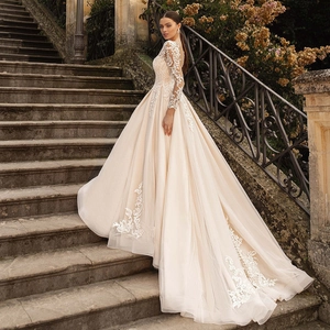 Lace long sleeve wedding dress with champagne tulle train and embroidery