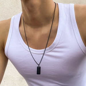 Minimalist black rectangle pendant necklace with thin metal chain on male model wearing vest
