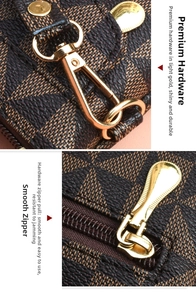 Detail of high-quality gold metal zipper and hook on brown checkered clutch bag