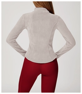 Detail showing slim fit polar fleece jacket with curved back stitching and soft texture