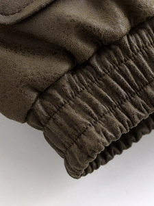 Close-up of windproof elastic ribbed cuffs on a dark brown bomber jacket for women