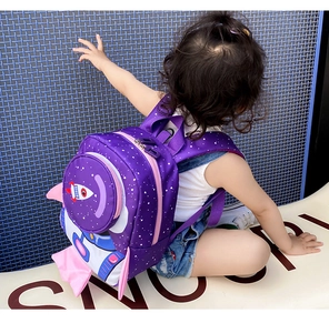 Toddler using the purple rocket safety backpack with anti-lost strap outdoors