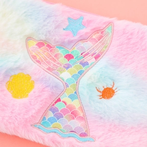 Close-up of plush mermaid tail bag with colorful shell, crab and star embroidery details