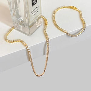 Elegant gold tennis chain necklace and bracelet set with sparkling cubic zirconia crystals