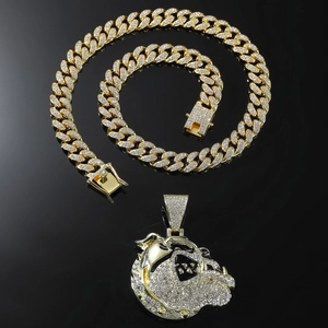 Hip hop iced out bulldog pendant necklace with gold cuban chain on a black background