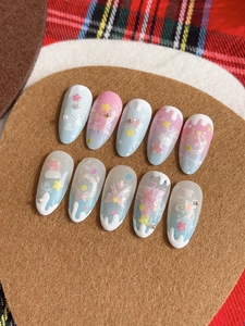 Close-up of pink and white Christmas nail art with 3D snowflakes and glitter details