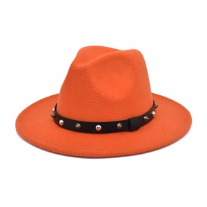 Close-up of orange wool fedora hat with black leather belt and silver metal studs
