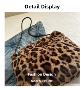 Detail of soft leopard print faux fur tote bag with slim black shoulder strap and denim jacket