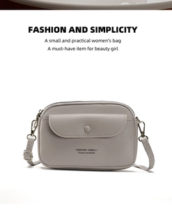 Detail shot of grey pebbled faux leather mini crossbody bag with metal zipper and magnetic flap