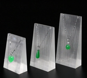 Three-piece acrylic necklace display stand set for jewelry pendants on black background