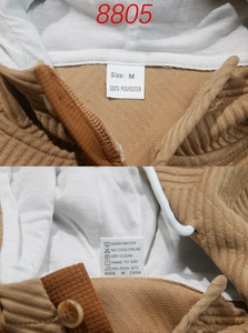 Detail of camel textured hoodie showing size M label and 100% polyester fabric care tags